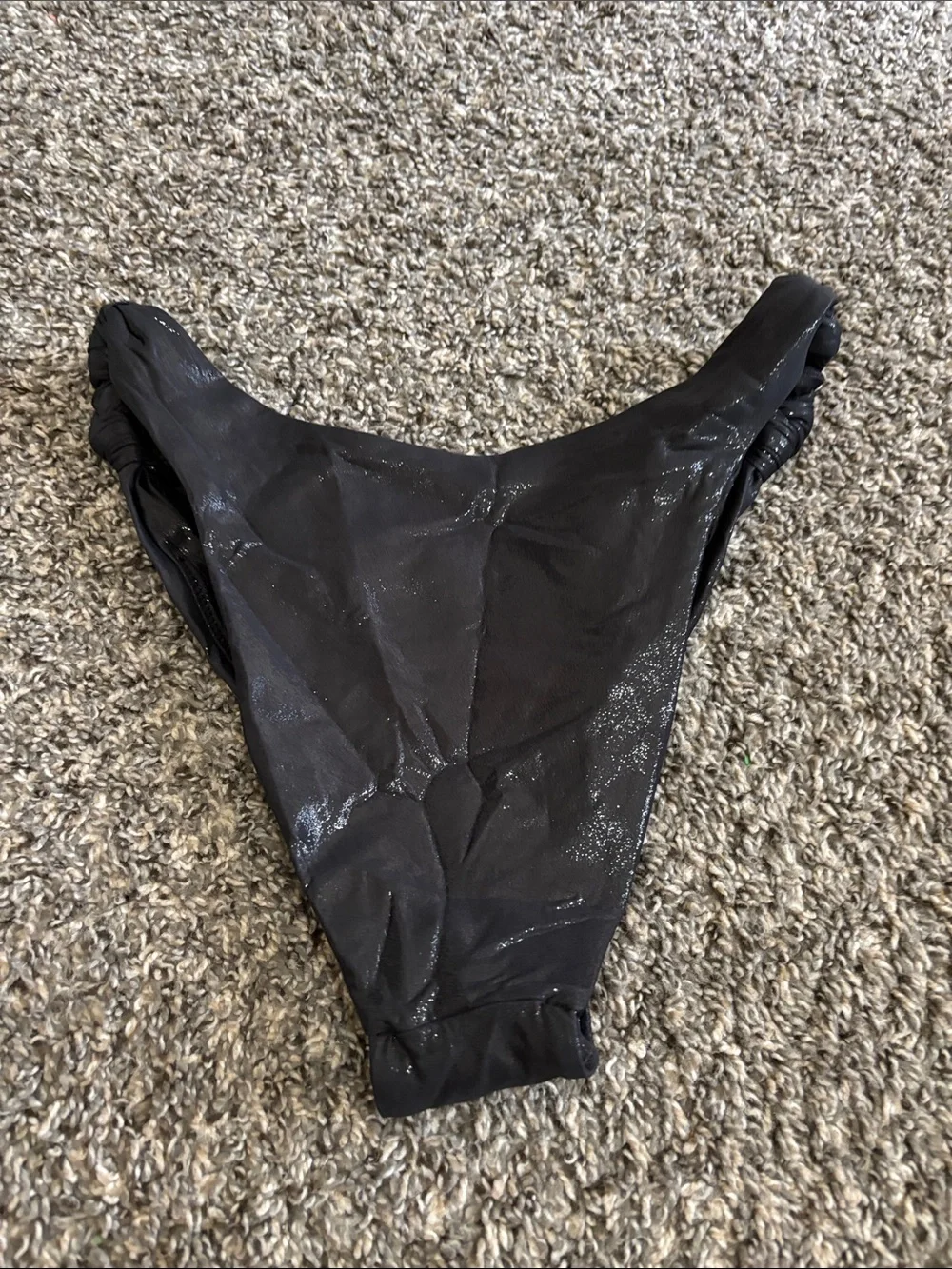 SKIMS Liquid Shine Swim Knotted Cheeky Tanga Bottom in the color Onyx M beach